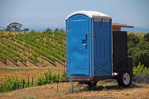 deluxe porta potty near a vineyard